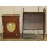 A small Victorian oak wall mounted bathroom cabinet enclosed by a single door with shield shaped