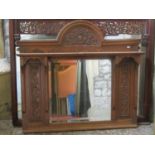 Edwardian over mantle mirror with centralised bevelled edge plate within an oak carved and moulded