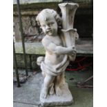 A reclaimed garden ornament in the form of a standing cherub holding a cornucopia (af), 78 cm high