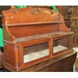 A Regency mahogany wall cupboard enclosed by a pair of doors beneath a shaped and carved back, 117cm