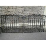 A pair of heavy gauge ironwork driveway entrance gates with S scroll detail, 240 span x 104 cm high