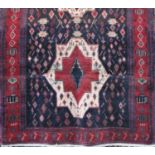 A Nahavan Village full pile rug, with twin medallion decoration upon rich blue and red ground, 290 x