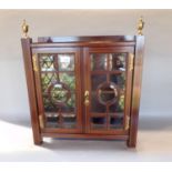A good quality Edwardian table top cabinet with twin bevelled glass glazed doors and butterfly