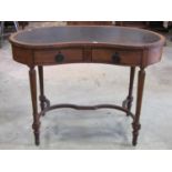 An Edwardian mahogany kidney shaped ladies writing table with inset leather top, fitted with two