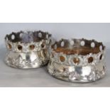 Good quality pair of silver plated wine coasters with cast pierced geometric rims and further floral