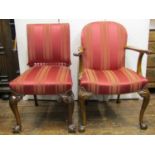A pair of George II style walnut elbow chairs, the forelegs with shell carved knees raised on claw