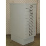 A small steel filing cabinet of ten drawers, 28cm wide