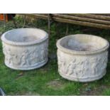 A pair of reclaimed planters of circular form with harvesting cherub relief detail, 60 cm in