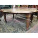 A Victorian mahogany D end extending dining table raised on four turned tapering and fluted