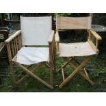 A pair of simple stripped pine folding trestles together with two weathered directors type chairs (