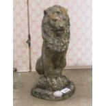 Small reclaimed garden ornament in the form of a seated lion 35cm high