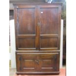 A Georgian oak food cupboard on two tiers, enclosed by two pairs of panelled doors within a