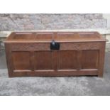 An early 18th century oak coffer, the front elevation enclosed by four rectangular panels with