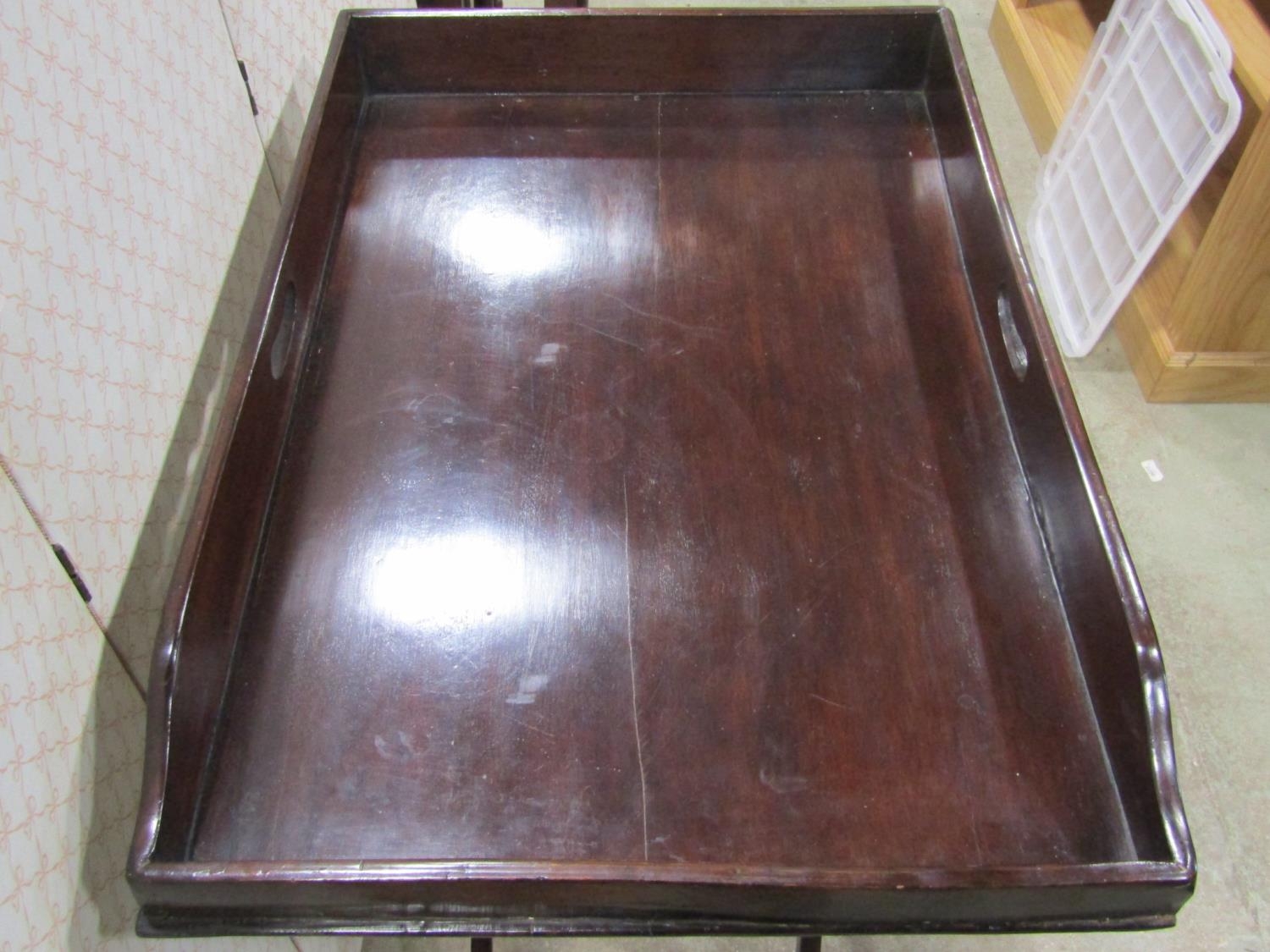 A butlers tray and stand of usual form, the tray with shaped outline raised on a folding framework - Image 2 of 2