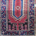 Unusual Cirjan rug with large central blue and white floral medallion and chunky still lives upon