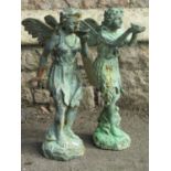 Two small weathered cast iron ornaments in the form of fairies/nymphs in standing pose, one
