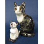 A Winstanley model of a tabby and white seated cat with painted mark to base, 25 cm tall