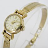 Vintage ladies 9ct Rolex precision cocktail watch, the champagne dial with baton markers, with art