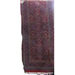 Belgian wool runner with intricate geometric floral decoration upon a red ground, 330 x 70cm