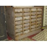 A vintage industrial steel floorstanding bank/nest of 28 drawers presented in towers of seven,