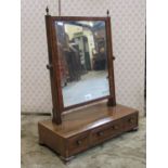 A Georgian mahogany toilet mirror, the box base fitted with three frieze drawer on short ogee