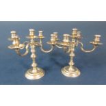Pair of unusual silver taper-stick candelabra, upon stepped circular bases, maker William Comyns &