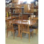 G Plan teak wood drop leaf dining table on swept supports, together with a set of six rail back