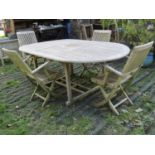 A Made On Earth weathered teak D end extending garden table with slatted top and additional bi-