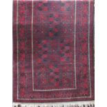 Turkoman type rug with panel decoration upon a red ground, 240 x 120cm
