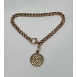 9ct curb link bracelet hung with a pierced monogrammed charm, 9.9g