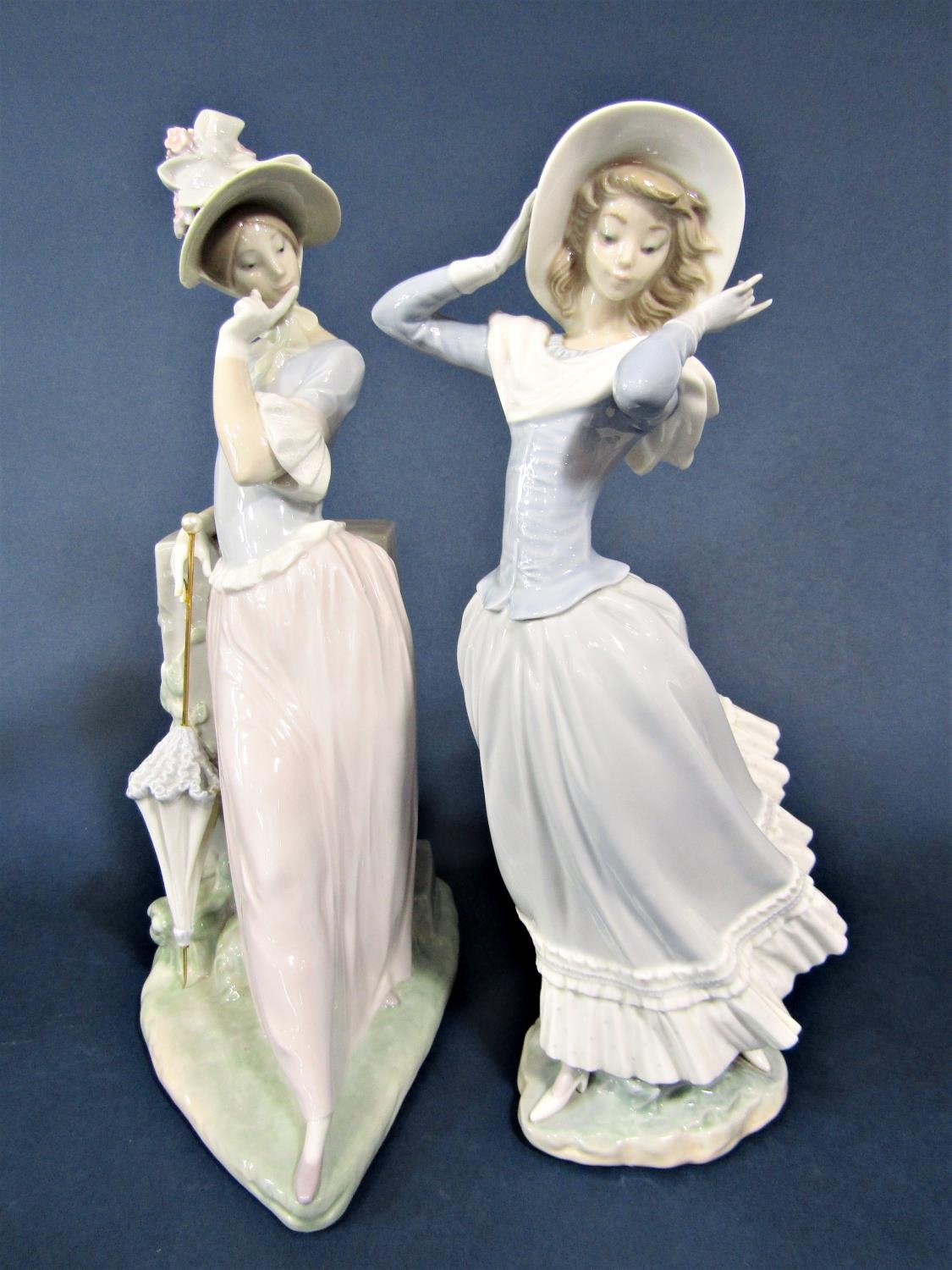 A large Lladro figure of an elegant lady with bonnet and parasol, 38 cm tall approximately, together