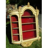 A 19th century wall mounted, glazed cabinet, the central door flanked by two open D ends, with