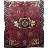 Good Saveh rug with central blue medallion, framed by further floral still lives upon a washed red