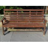 A stained soft wood three seat garden bench with slatted framework, 166 cm long