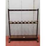 A 19th century mahogany boot stand with moulded frame turned pegs and platform stretcher