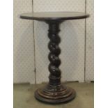 An oak occasional table, the circular top raised on a spiral column and moulded base, 58cm diameter