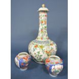 A large 19th century oriental Famille Verte bottle shaped vase and cover with drawn neck, reserve