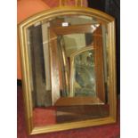 Moulded gilt framed wall mirror of arched form enclosing a bevelled edge plate 92 cm x 71 cm