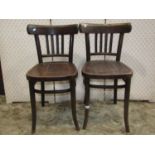 Four vintage Bentwood cafe chairs, three matching singles plus a further elbow chair with pierced