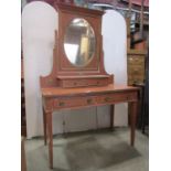 An Maple and co Edwardian dressing table in a salmon pink [painted colourway, fitted with two frieze