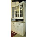 An old painted pine kitchen dresser, the base enclosed by a pair of rectangular moulded panelled