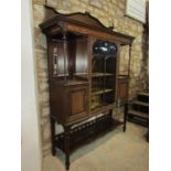 A good quality inlaid mahogany display cabinet enclosed by a central glazed panel door, flanked by