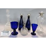 A pair of antique blue glass decanters with cork stoppers and inscribed mother-of-pearl knops for