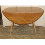 An Ercol light elm drop leaf dining table, 112cm long