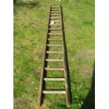 A vintage wooden sixteen rung ladder of slightly tapered form, 3.78 metres long (af), to be sold for