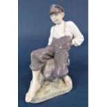 A Royal Copenhagen model of a seated boy, marked to base 1659, 30cm tall approx