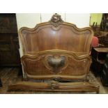 A late 19th century walnut bedstead, the footboard with parquetry detail, the central panel