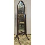 A reproduction cheval mirror with moulded arched mahogany frame raised on swept supports