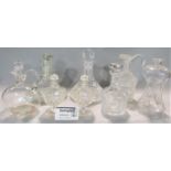 A large collection of mainly cut glass decanters and others (collection)
