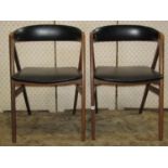 A pair of mid 20th century teak wood dining chairs with upholstered seats and curved back